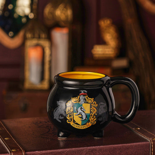 Hufflepuff cauldron mug with black ceramic body, side handle, and gold crest