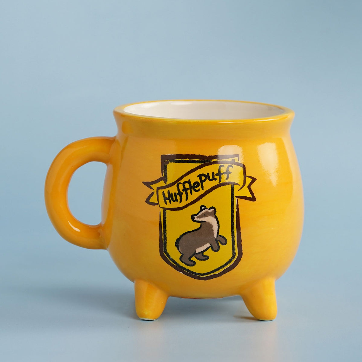 Yellow Hufflepuff cauldron-style mug with house crest and three legs