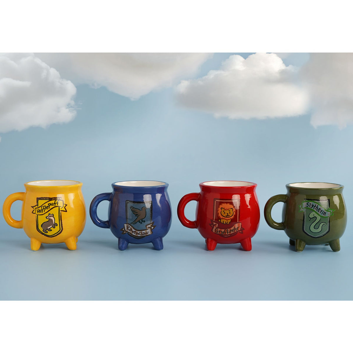 Hufflepuff cauldron mug shown among other house cauldron mugs