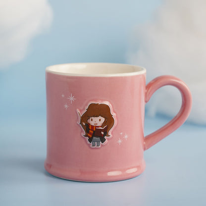 Pink ceramic mug with embossed Hermione-style character and star accents, side view