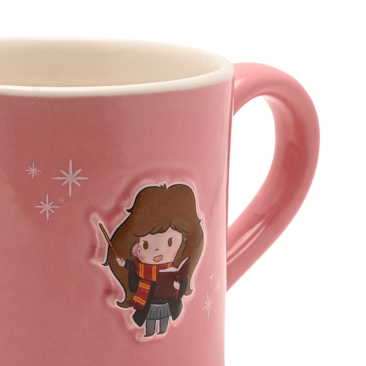 Pink ceramic mug close-up showing embossed character, wand detail, and star sparkles
