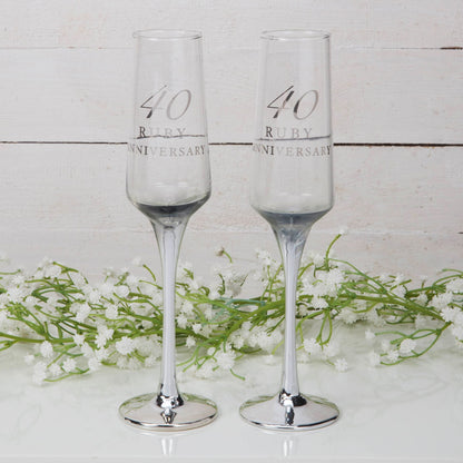 Pair of clear champagne flutes with "40 Ruby Anniversary" text on the glass
