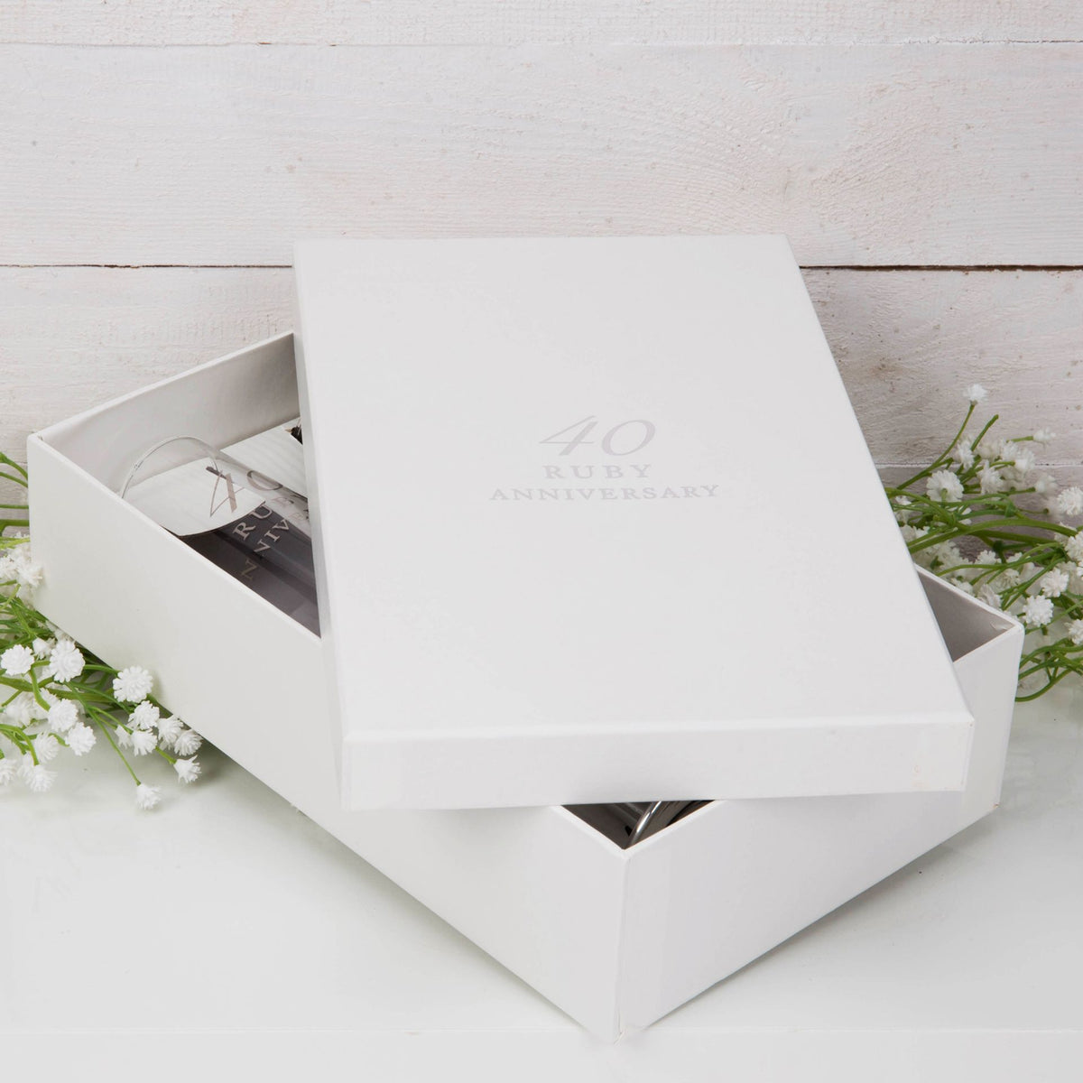 White presentation gift box with "40 Ruby Anniversary" lid and two flutes inside
