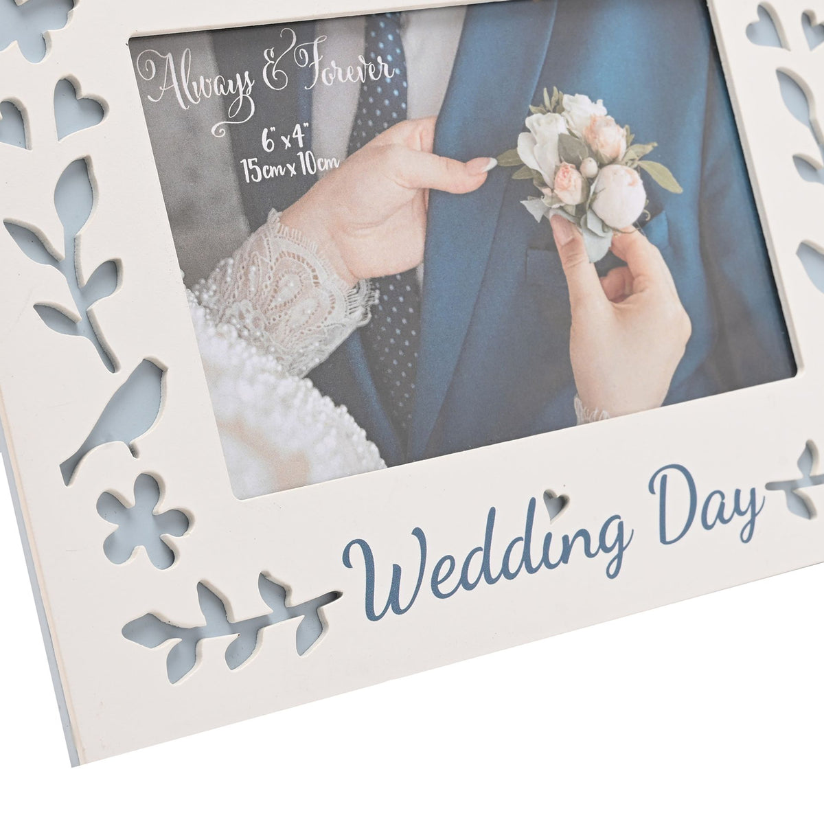 Close-up of white laser-cut photo frame with Wedding Day script and floral border, 6x4