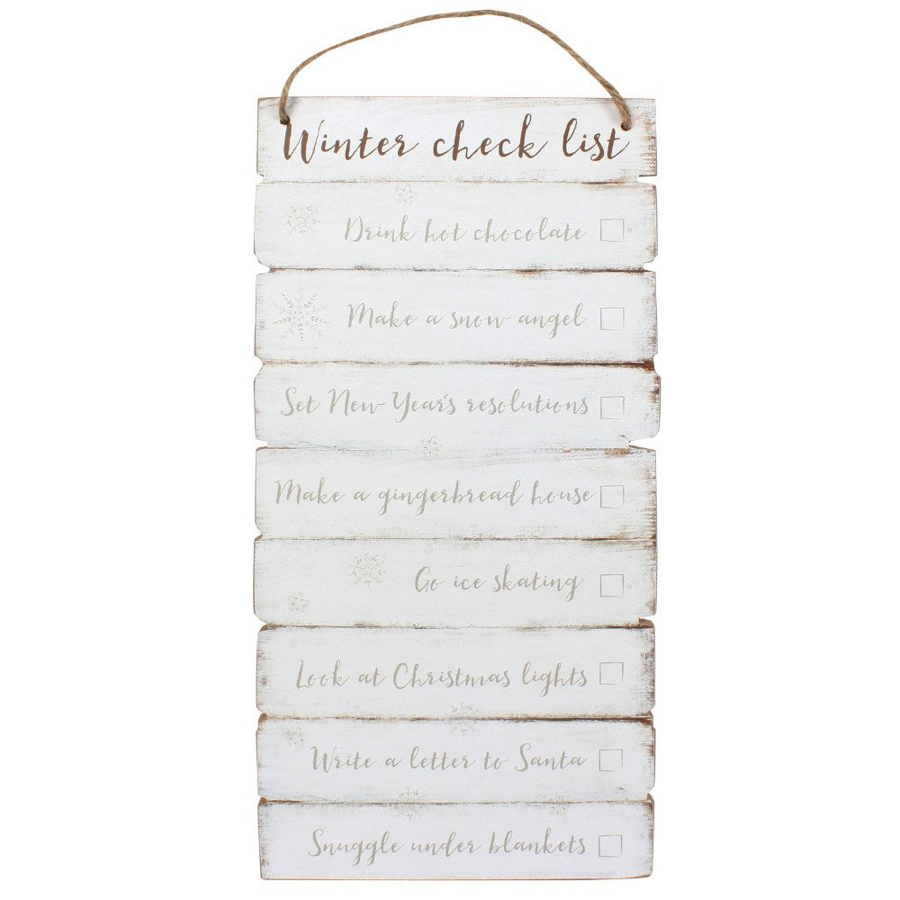 A rustic vertical wooden hanging sign with a jute rope loop at the top, featuring a white distressed finish and the words 'Winter check list' followed by holiday-themed checklist items in gray script with checkboxes.