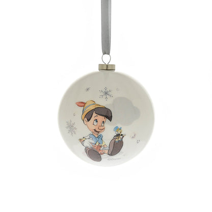 Round Christmas bauble with a child character holding a small toy, surrounded by snowflakes
