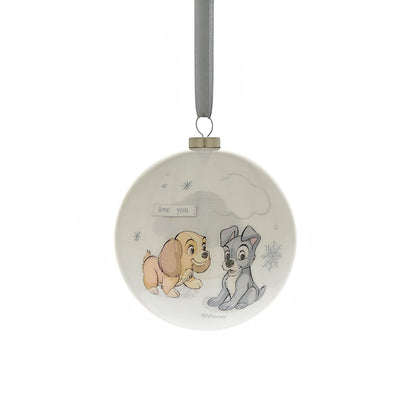 Round Christmas bauble with two animal characters sitting together, with small snowflake marks