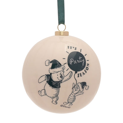 Round Winnie the Pooh bauble in cream with “Party Season” text and characters