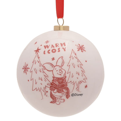 Round Winnie the Pooh bauble in white with “Warm Cozy” text and snowy forest scene