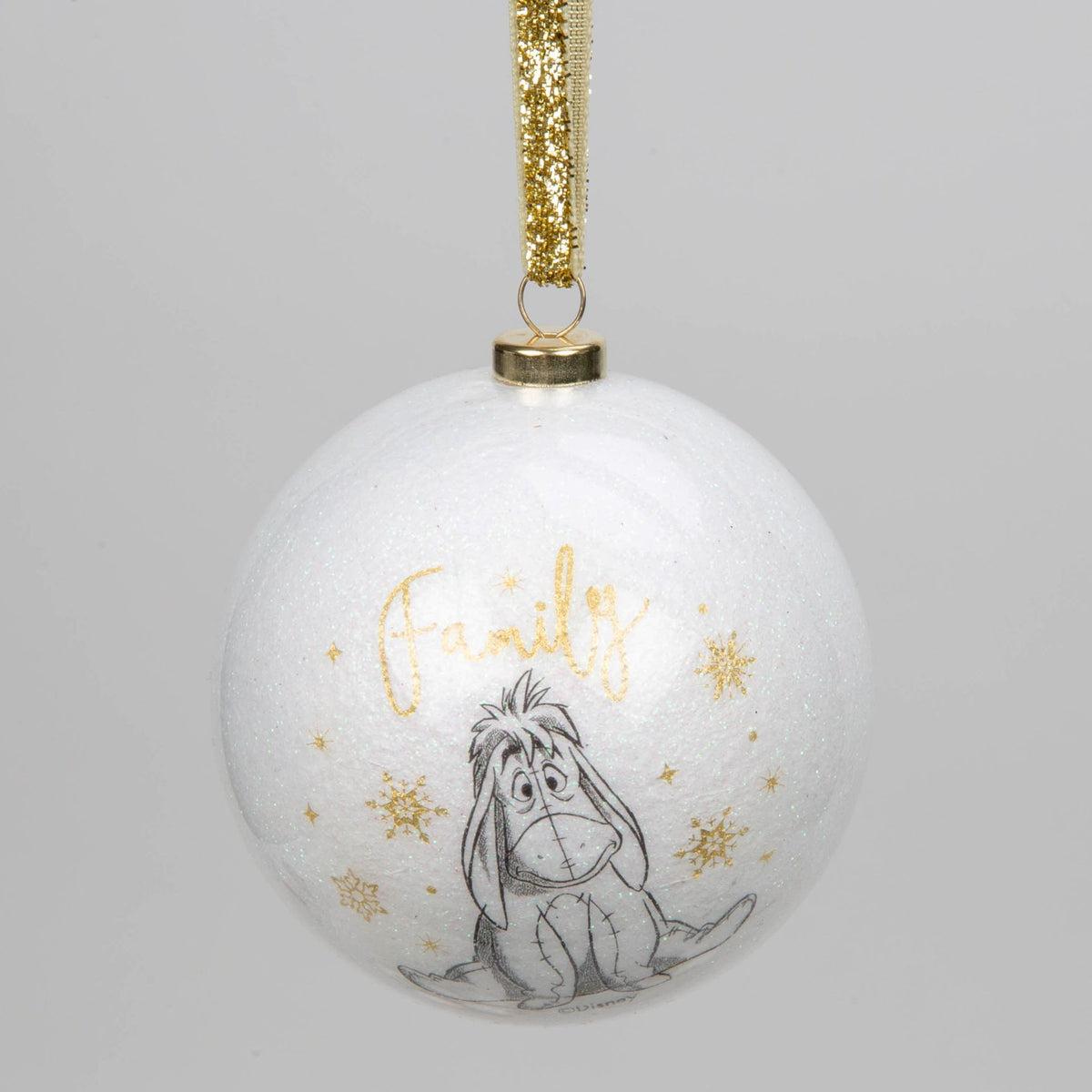 White acrylic glitter bauble with Eeyore and gold text, hanging from gold ribbon