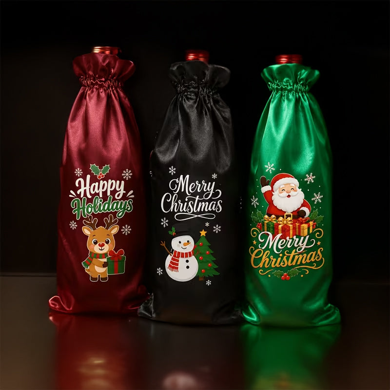 Three Christmas-themed satin bottle covers standing upright on a dark reflective surface. The left cover is deep red with a reindeer and 'Happy Holidays' print, the center is black with a snowman and 'Merry Christmas' print, and the right is green with Santa and 'Merry Christmas' print.