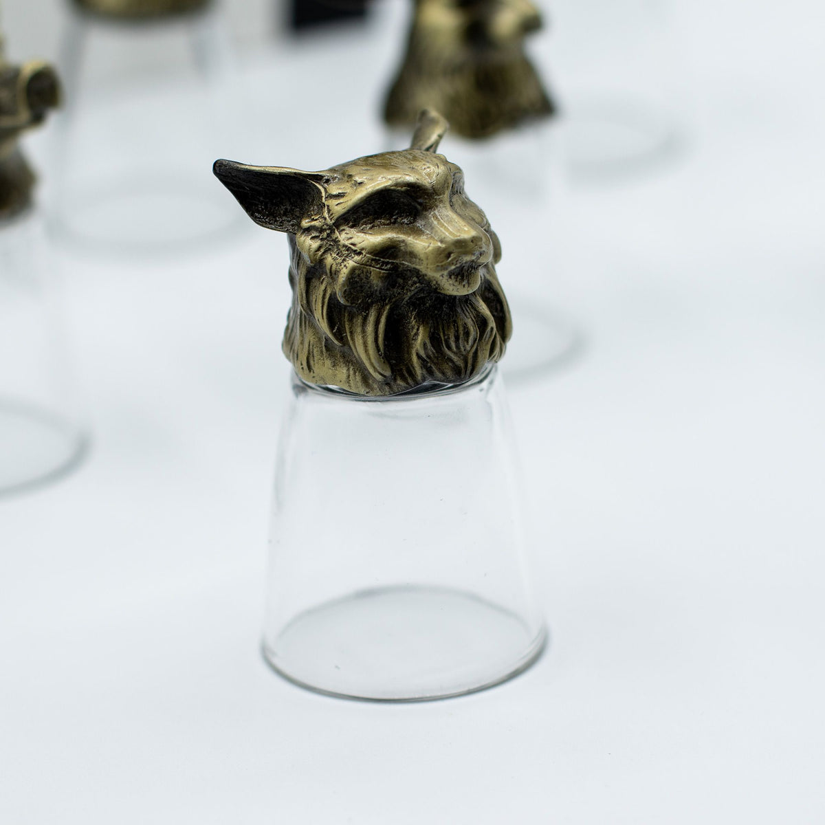Antique bronze deer-head bottom-up shot glass, clear glass body