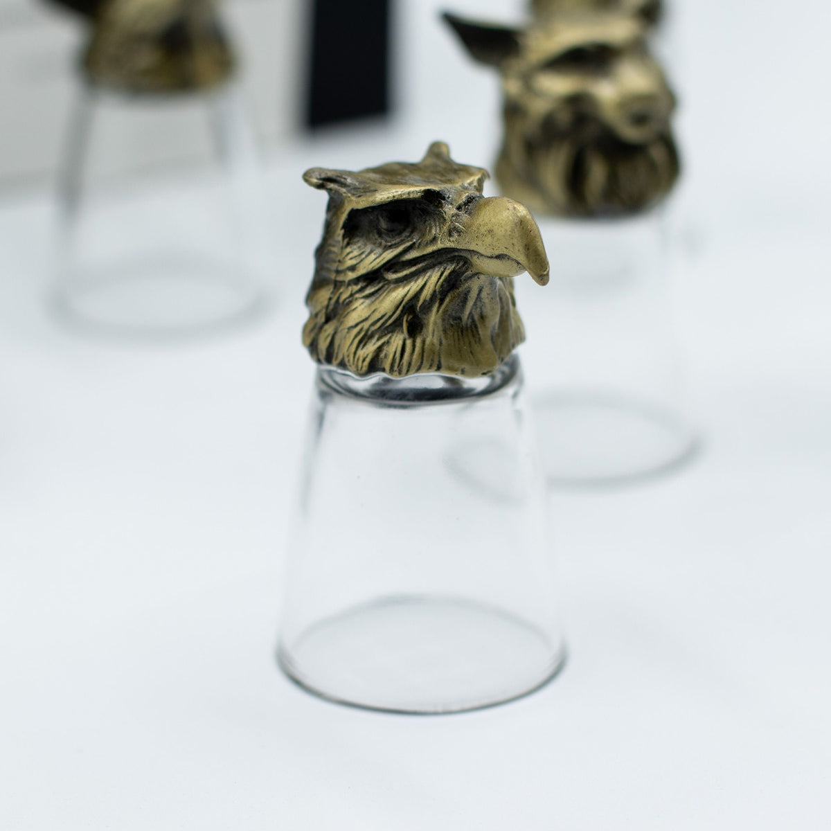 Antique bronze cat-like creature bottom-up shot glass, clear glass cup