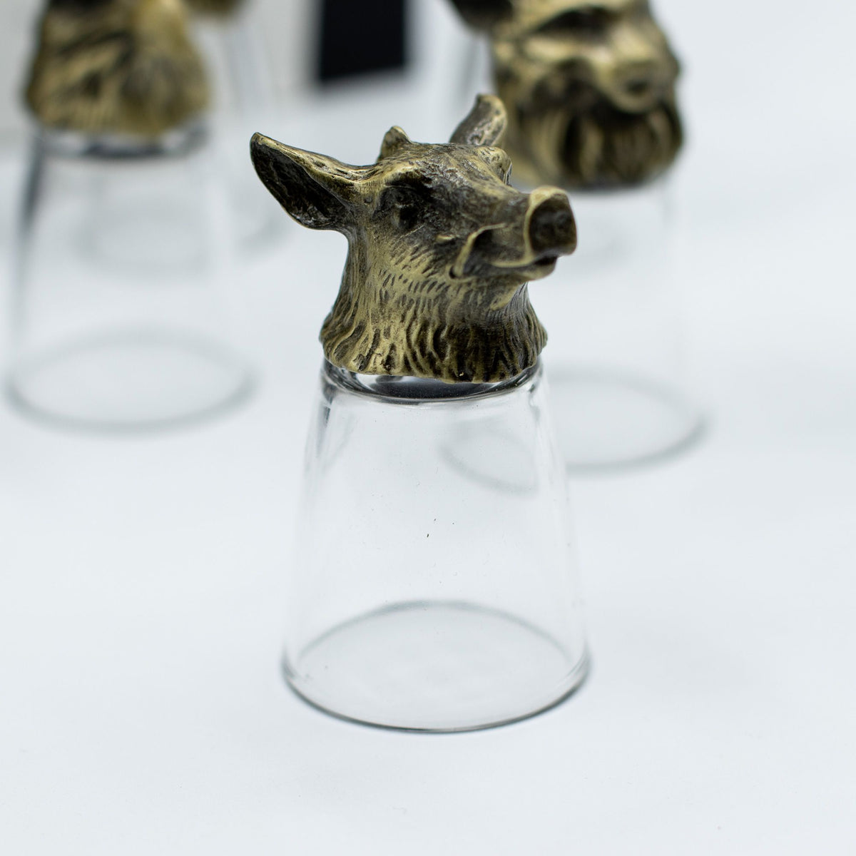 Antique bronze wolf-head bottom-up shot glass with clear glass body