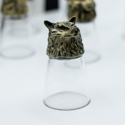 Clear shot glass with antique bronze bear-like creature topper, centered