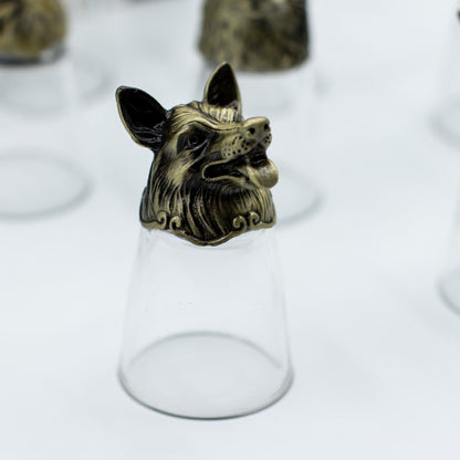 Clear shot glass with antique bronze cat-like creature topper, centered