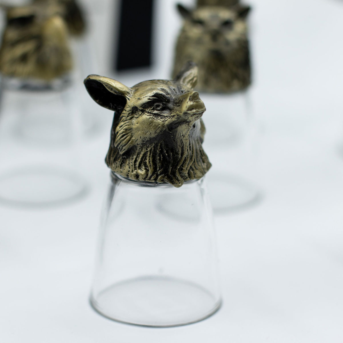 Clear shot glass with antique bronze wolf-like creature topper, front view