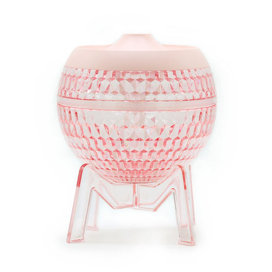 Pink planet-shaped humidifier with faceted glass look and three tripod legs
