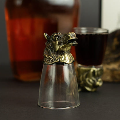 Close-up forest creature shot glass topper in antique bronze on clear glass