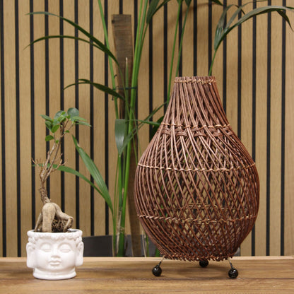 Dark brown rattan table lamp on display with teardrop lattice shade