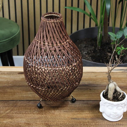 Dark brown rattan table lamp with teardrop woven shade and small round base feet