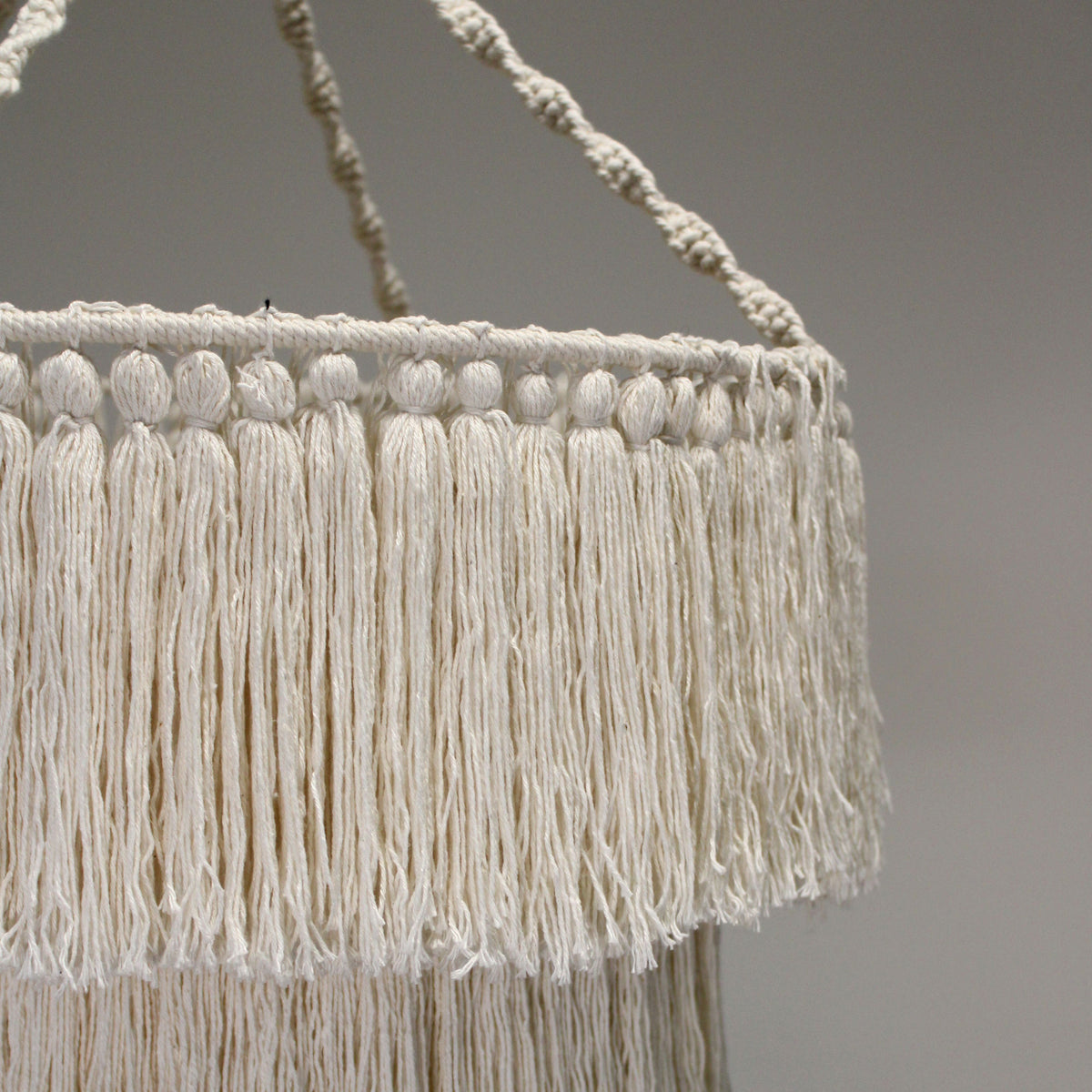 Natural macrame chandelier with round fringed shade and three hanging cords