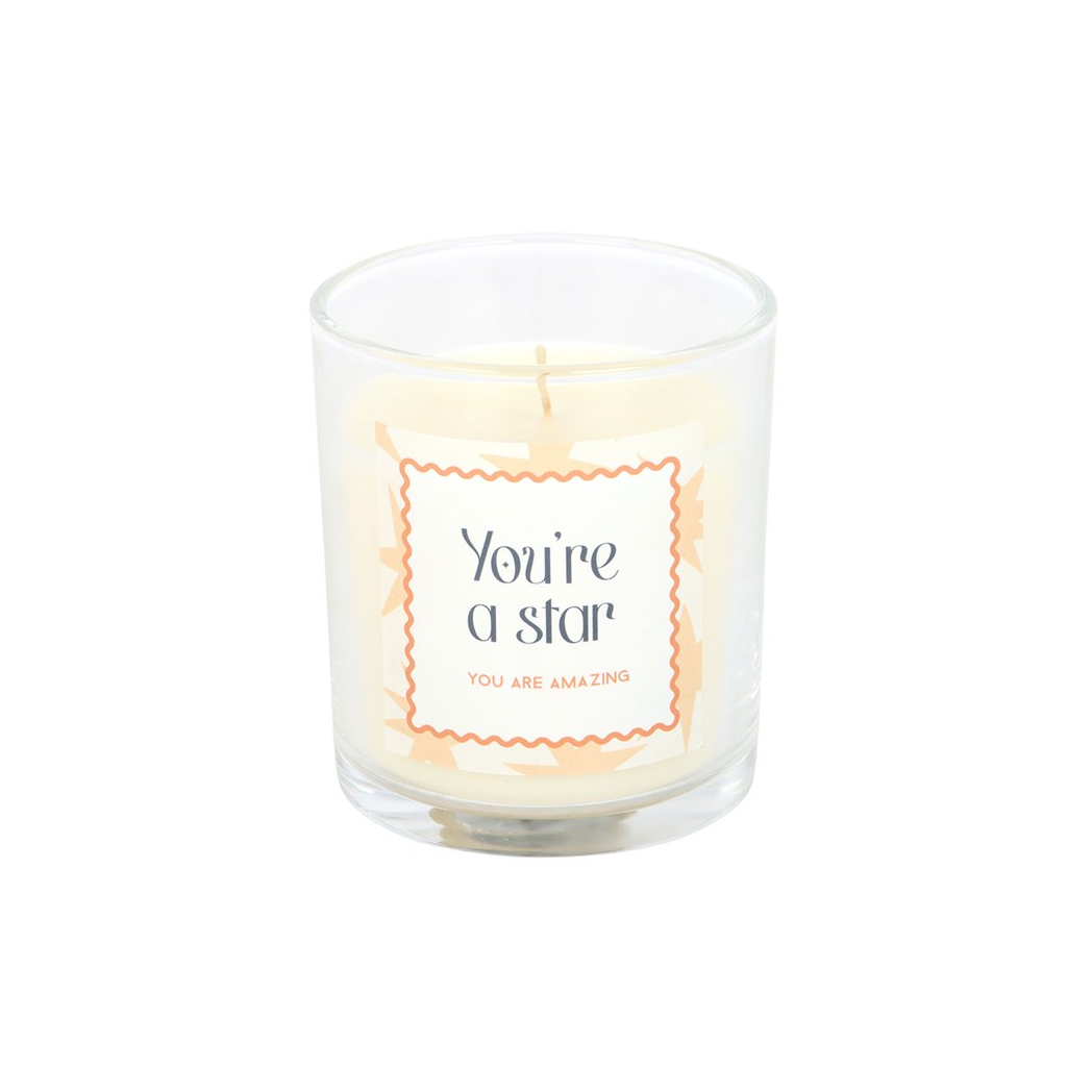 Star-themed scented candle in clear glass jar with orange “You’re a star” label and wick