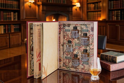 Whisky gift set book open to illustrated tasting pages with a small whisky glass