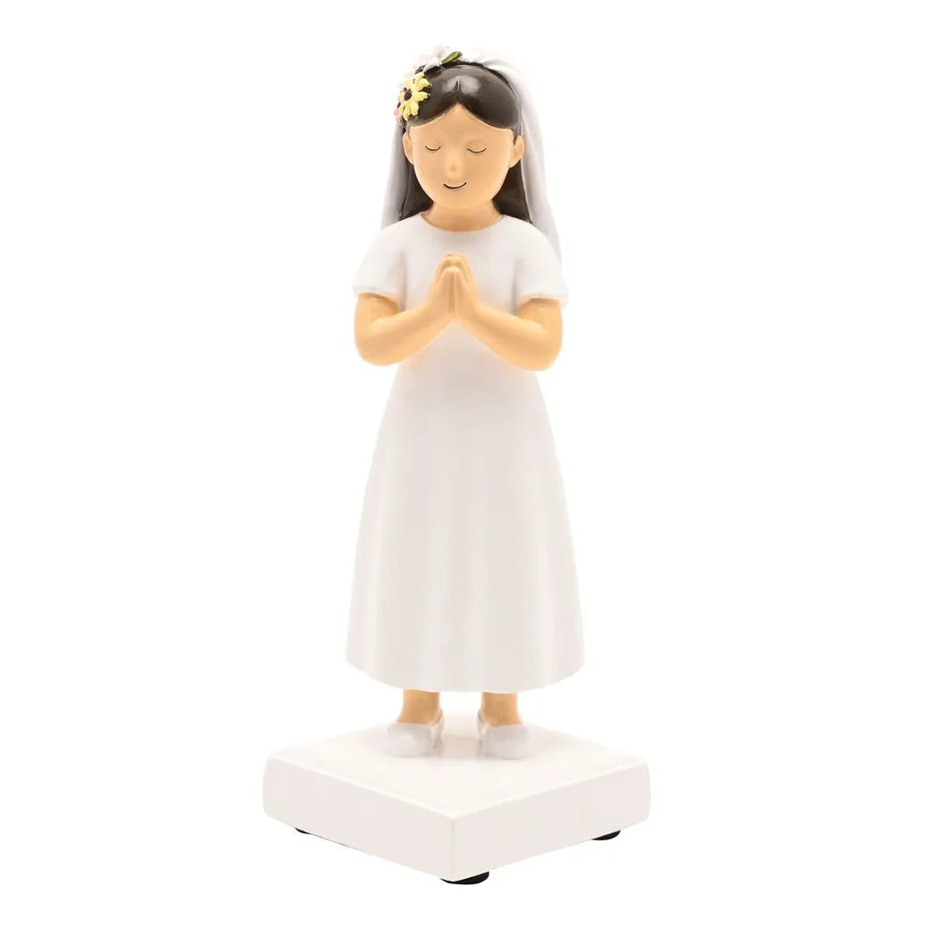 Communion girl figurine in white dress with veil and floral headpiece, hands in prayer