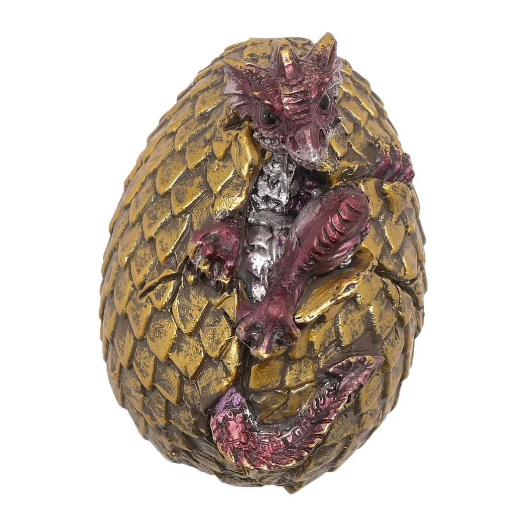Golden dragon egg figurine with purple-red dragon face and silver detailing