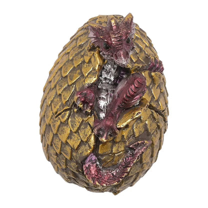 Golden dragon egg figurine with purple-red dragon face and silver detailing