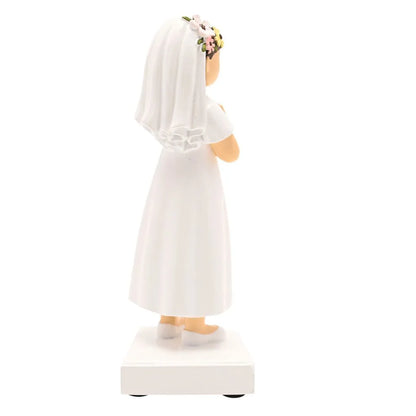 Back view communion girl figurine with veil and floral crown, white dress, hands held together