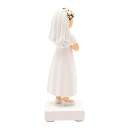 Rear three-quarter view communion girl figurine, white dress with lace trim, floral hairpiece
