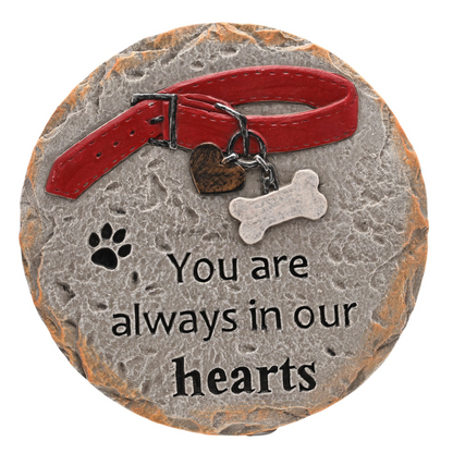 Pet memorial stone with red collar, paw print, bone charm, text “You are always in our hearts”.