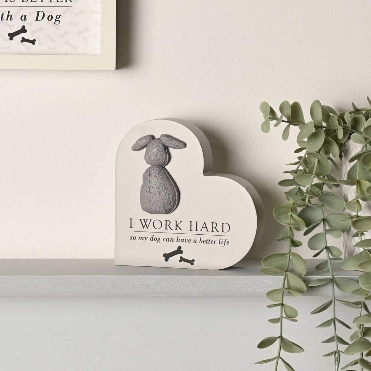 Heart-shaped dog plaque with gray dog figure and quote, “I WORK HARD so my dog can have a better life”