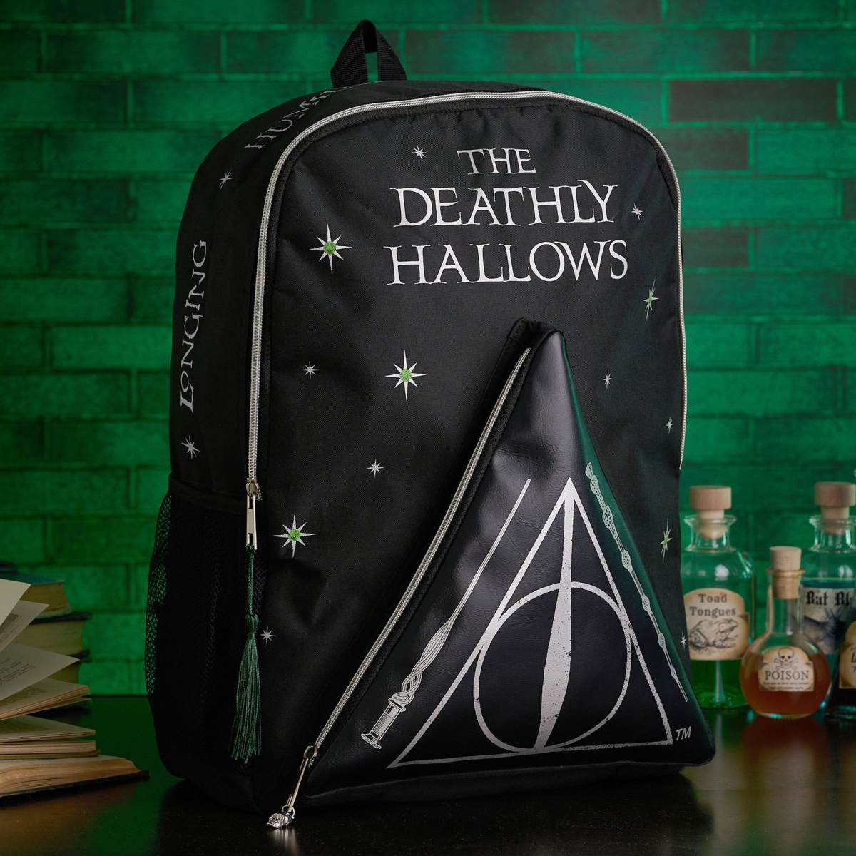 Harry Potter Deathly Hallows dark arts backpack, black with front triangle emblem and tassel.