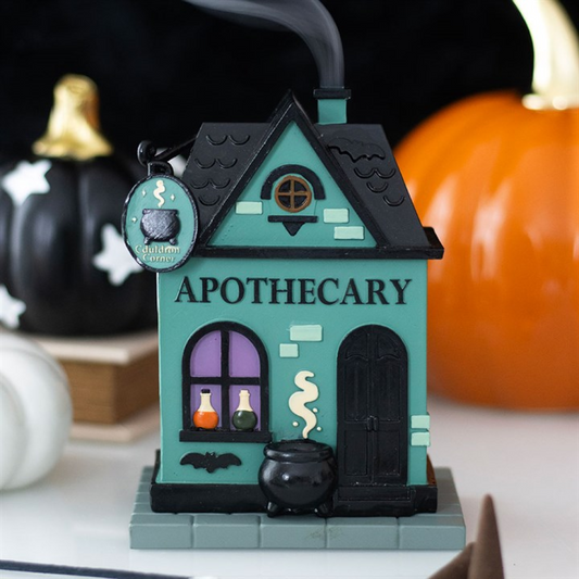Teal house-shaped incense cone holder with black roof and front cauldron bowl detail