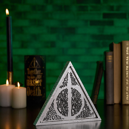 Triangular metal-look plaque with black Deathly Hallows-style symbol and inscriptions