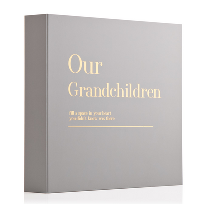 Coffee table scrapbook album with gray cover and gold 'Our Grandchildren' title