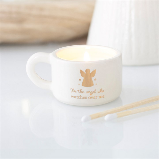 White ceramic tealight holder with handle, angel silhouette and gold “watches over me” text