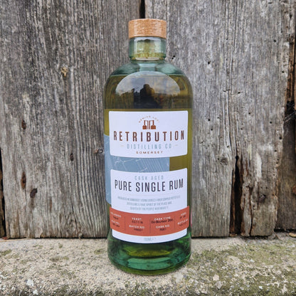 Single cask aged rum bottle with green glass and cork, front label visible