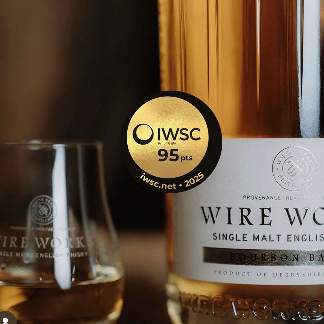 Bottle with IWC 95 pts sticker and Wire Works label, whiskey glasses in view
